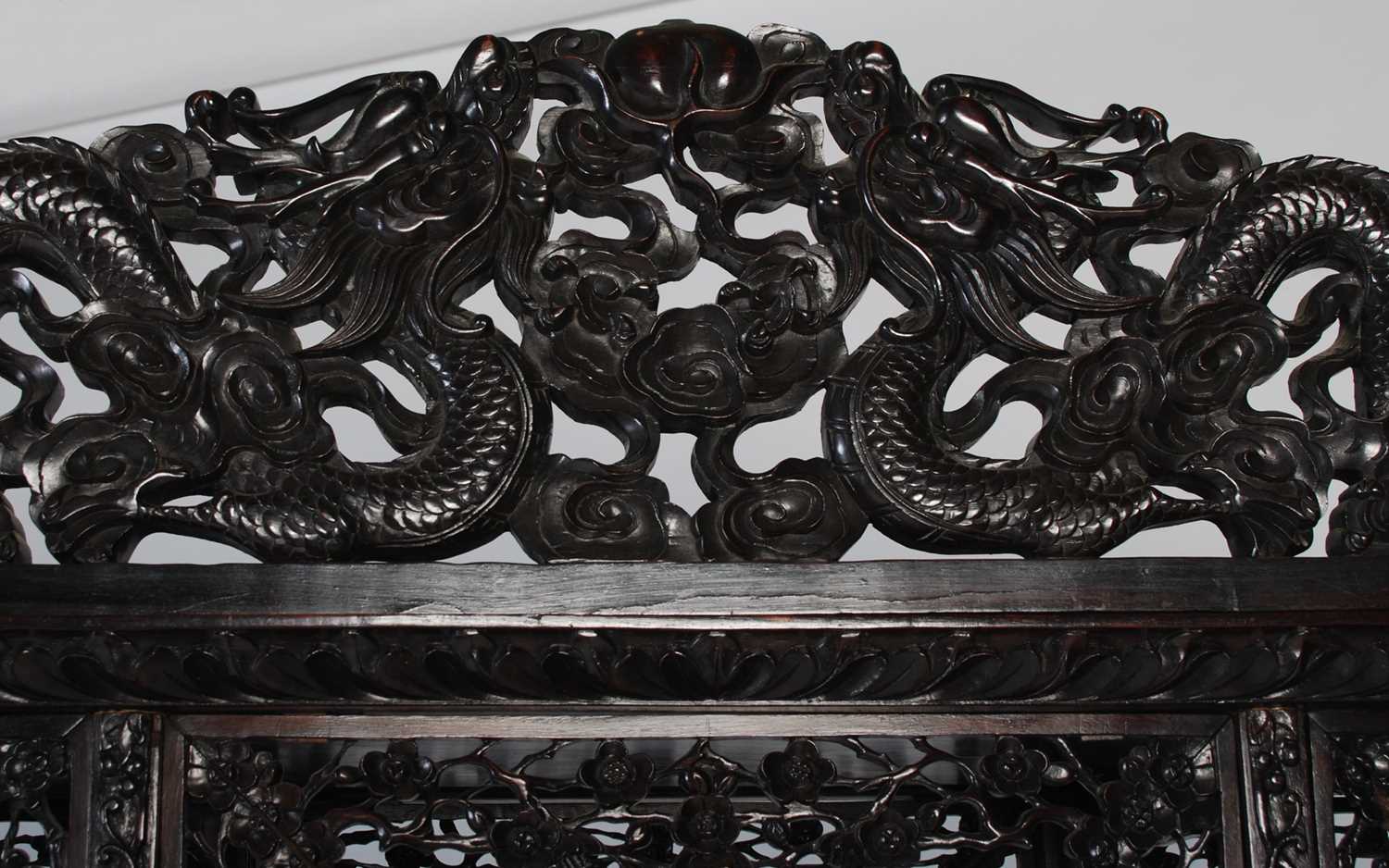 A late 19th century Chinese dark wood open display cabinet, with carved and pierced surmount of - Image 3 of 8