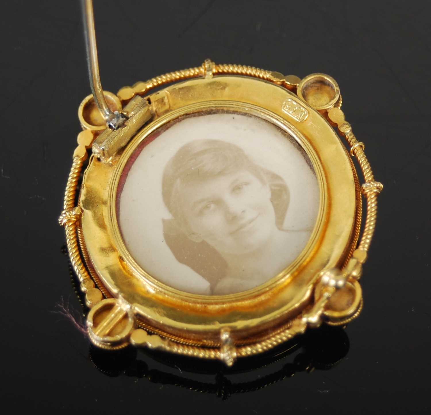 A late 19th century yellow metal locket brooch, centred with a stylised flower, the reverse with - Image 4 of 4