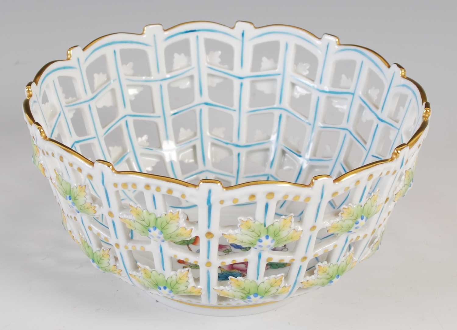 A Herend porcelain basket, 20th century, decorated with floral spray to the interior, the exterior