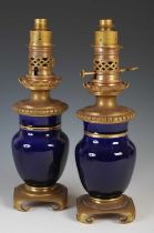 A pair of gilt metal mounted blue pottery table lamps, formally oil burning paraffin lamps, 39cm
