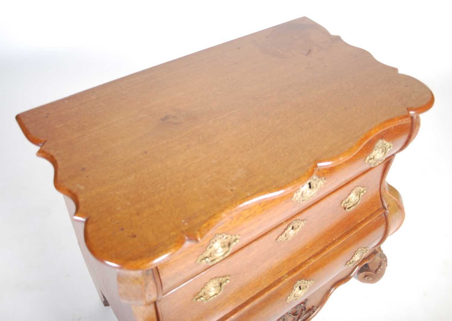 A late 18th century Dutch oak bombe chest, the shaped rectangular top above three long drawers and a - Image 2 of 9