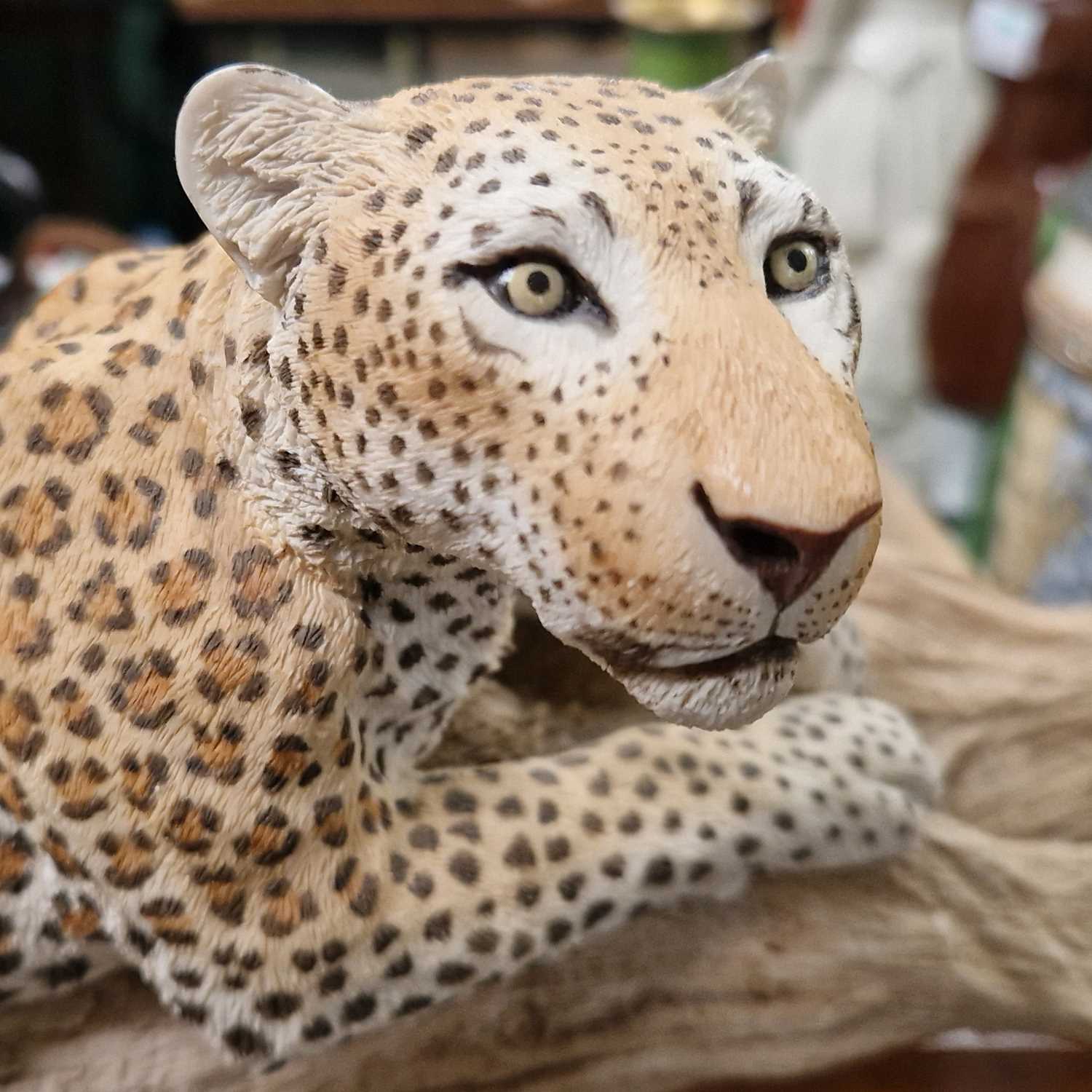 A resin sculpture of a leopard on a branch, mounted to a wooden plinth. - Image 2 of 2