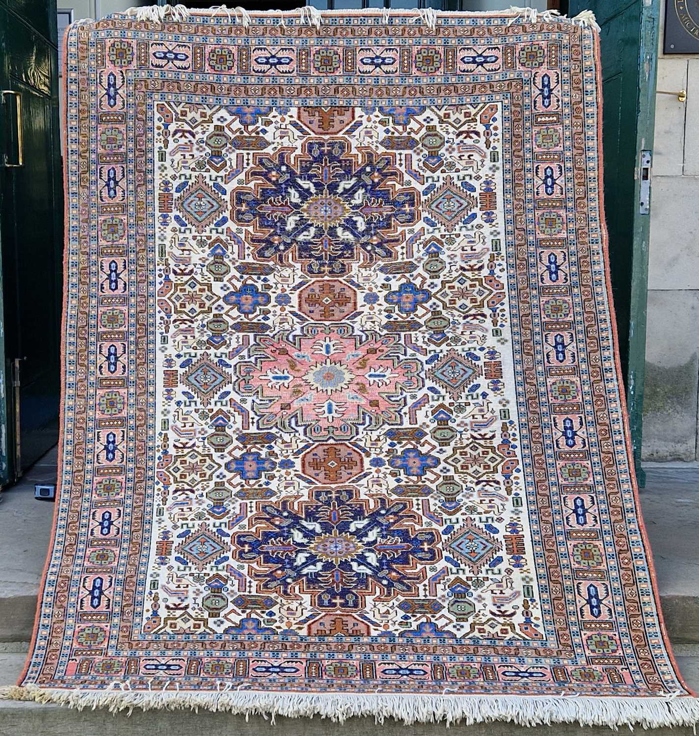 A Persian rug, 20th century, the ivory coloured rectangular ground centred with a pink floral - Image 2 of 4