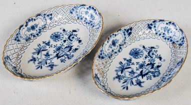 A pair of Meissen porcelain, blue and white onion pattern oval shaped dishes, with pierced rims