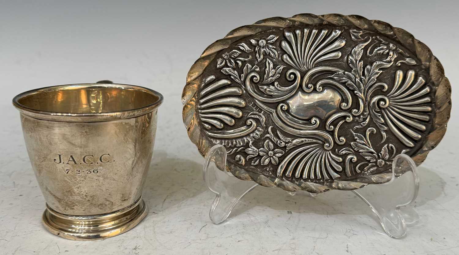 A Birmingham silver christening mug, together with a Birmingham silver oval shaped dish embossed