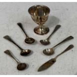 A Birmingham silver egg cup and spoon, together with four assorted salt spoons and butter knife.