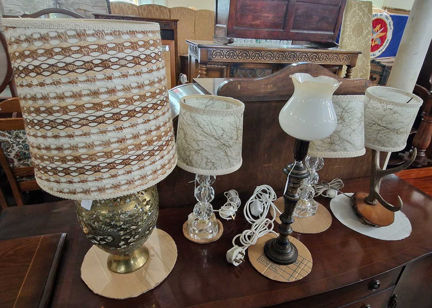 A Chinese pierced brass dragon form table lamp and shade; an antler horn table lamp and shade; black