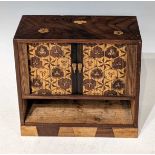 A Meiji period Japanese marquetry table cabinet, the upper section with tambor shutter opening to