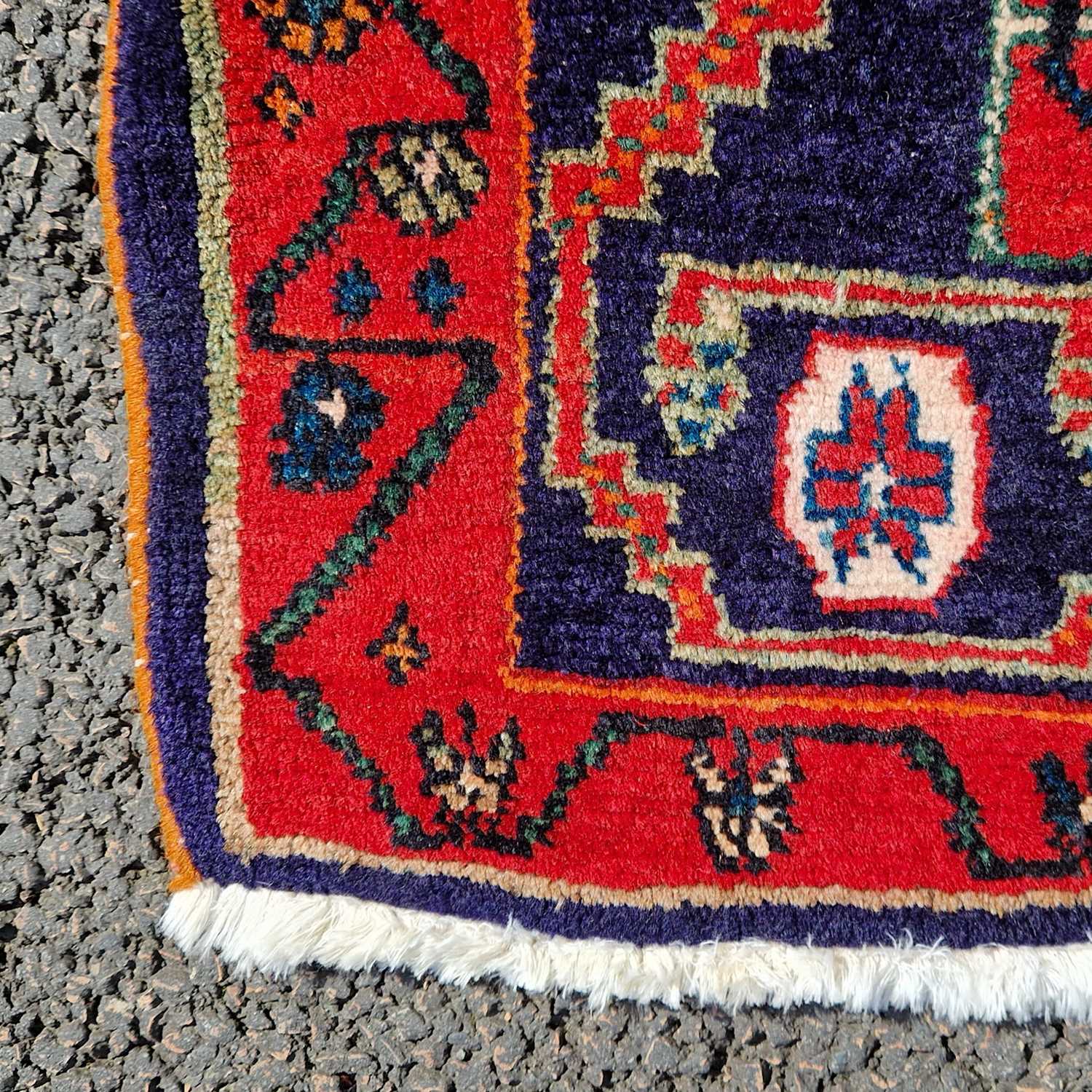 A Persian rug, 20th century, the rectangular cafe au lait coloured ground centred with a blue floral - Image 3 of 4