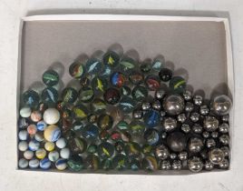 A collection of vintage marbles, to include 'Steelies', 'Cats eyes', and 'Milk glass' examples in