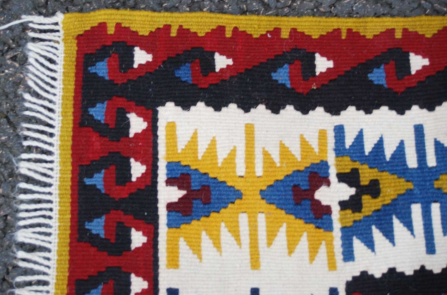 A Kelim rug, 20th century, the rectangular blue ground centred with a row of three lozenge shaped - Image 4 of 5