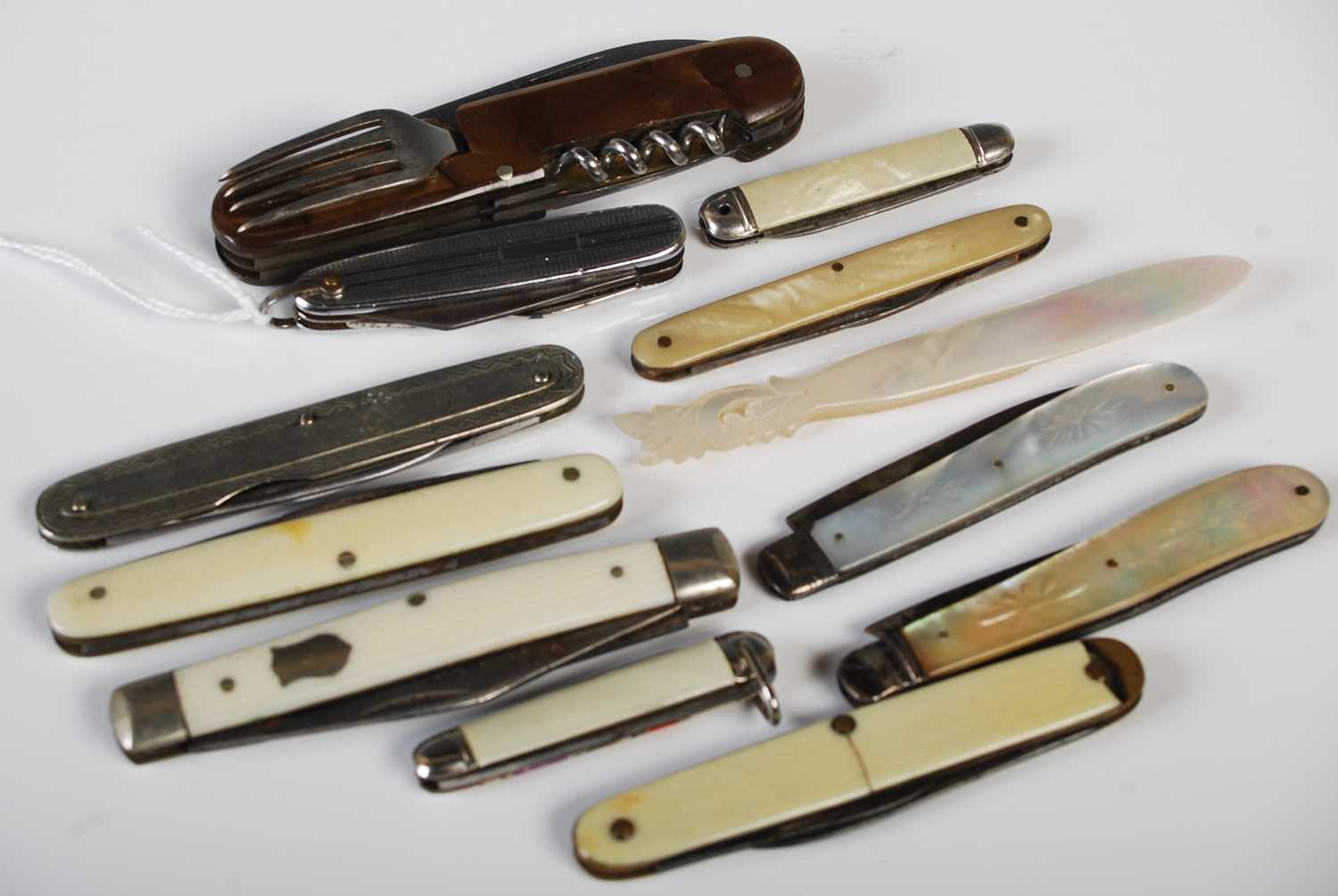 A collection of eleven assorted vintage pocketknives together with a carved mother of pearl page