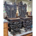 A pair of 19th century Italian Renaissance style stained wood, probably walnut, Sgabello hall chairs