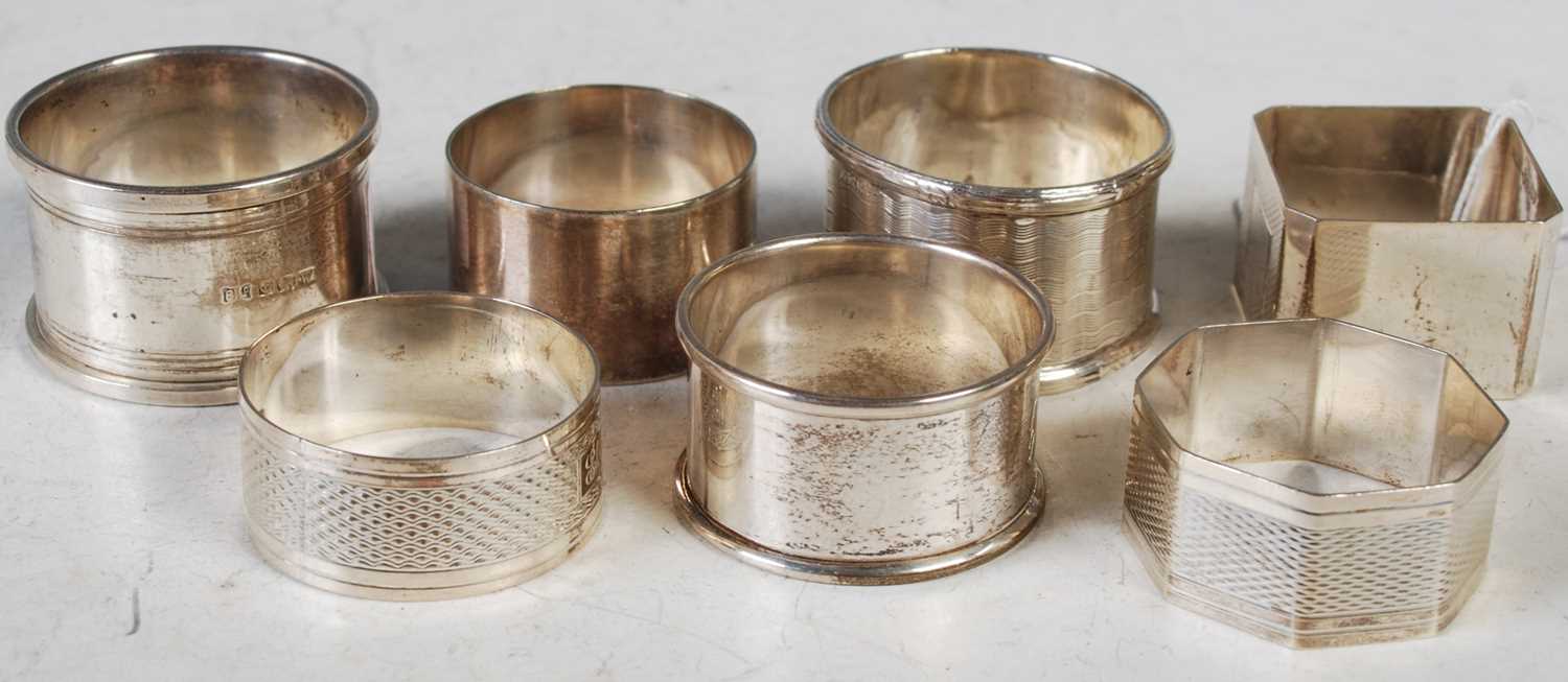 Seven assorted silver napkin rings, gross weight 4.9 troy ozs.