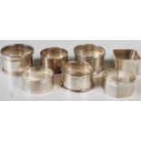Seven assorted silver napkin rings, gross weight 4.9 troy ozs.