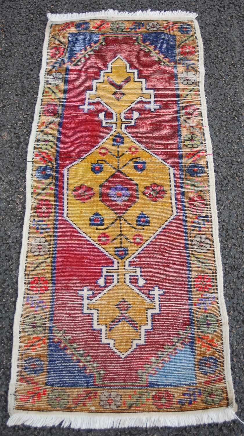 A small Persian rug/ mat, 20th century, the madder ground centred with an ochre-coloured medallion - Image 2 of 4