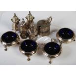 A set of four George V silver salts, Birmingham, 1912, each with Bristol blue glass liners, raised