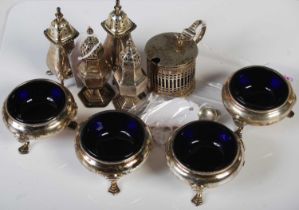 A set of four George V silver salts, Birmingham, 1912, each with Bristol blue glass liners, raised