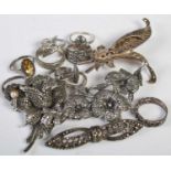 A collection of thirteen assorted white metal and marcasite jewellery pieces to include brooches and