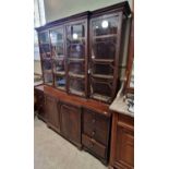 A reproduction mahogany breakfront bookcase, with moulded cornice over four glazed cupboard doors,