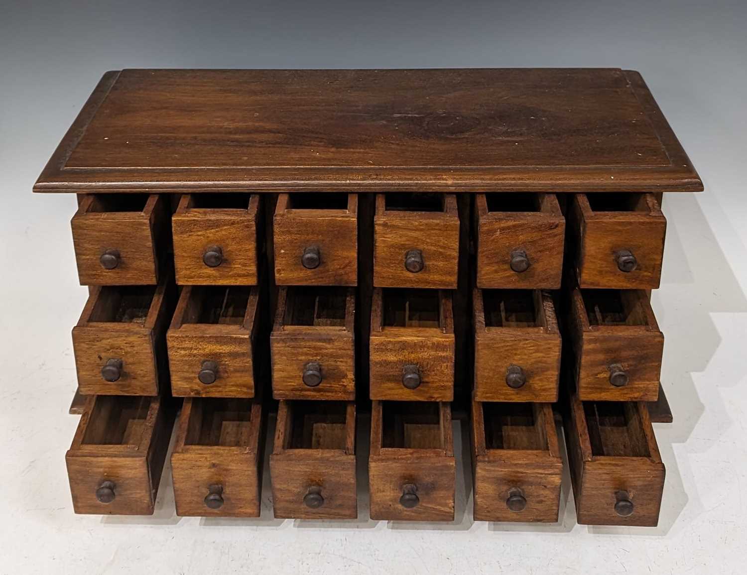A stained wood table top chest of eighteen small drawers, raised on four bracket feet, 32.5cm - Bild 2 aus 2