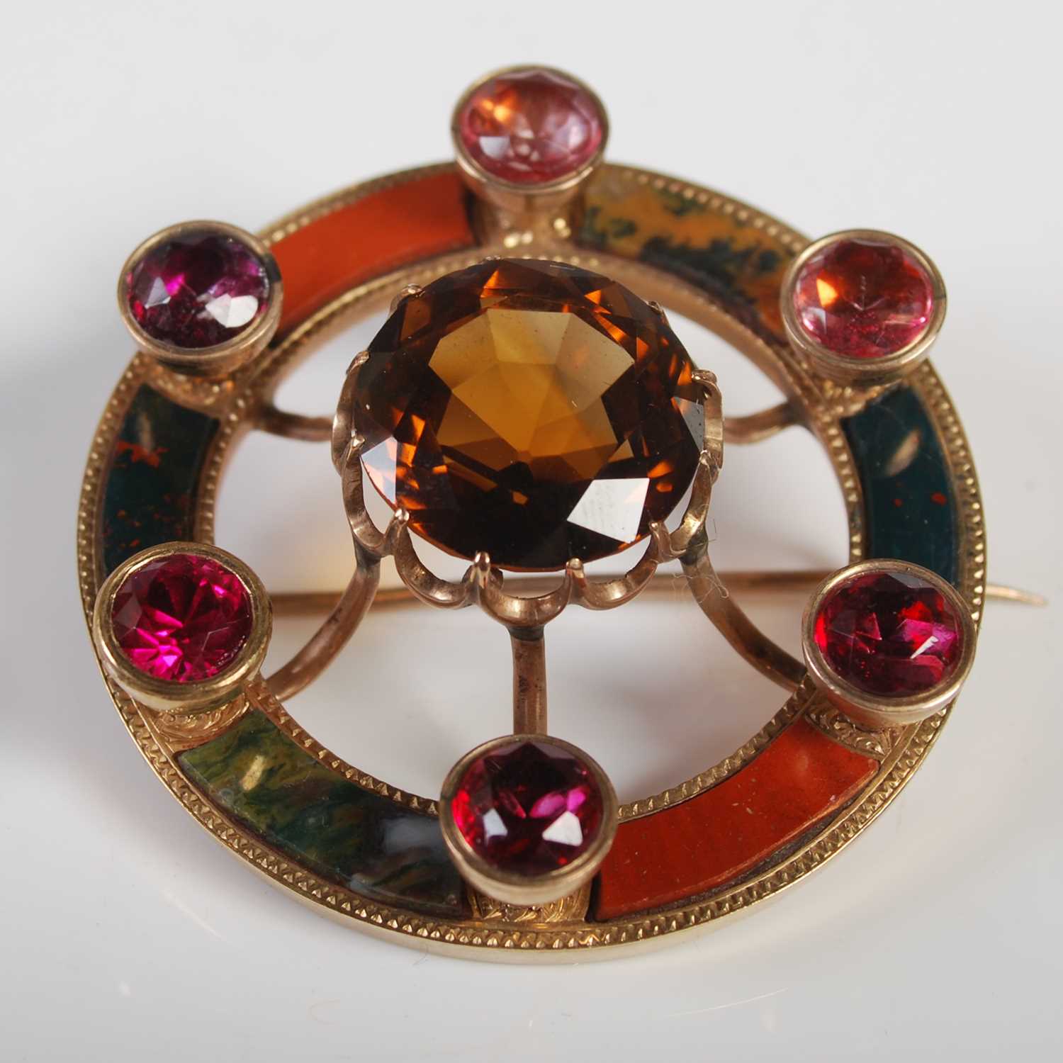 A Scottish yellow metal pebble set and semi-precious gem set brooch, of circular form, 39.9 mm