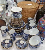 A Chinese porcelain blue and white part tea set with gilded borders, the teapot contained within a