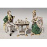 A Continental porcelain figure group of an elegantly dressed lady & gentleman, seated in chairs,