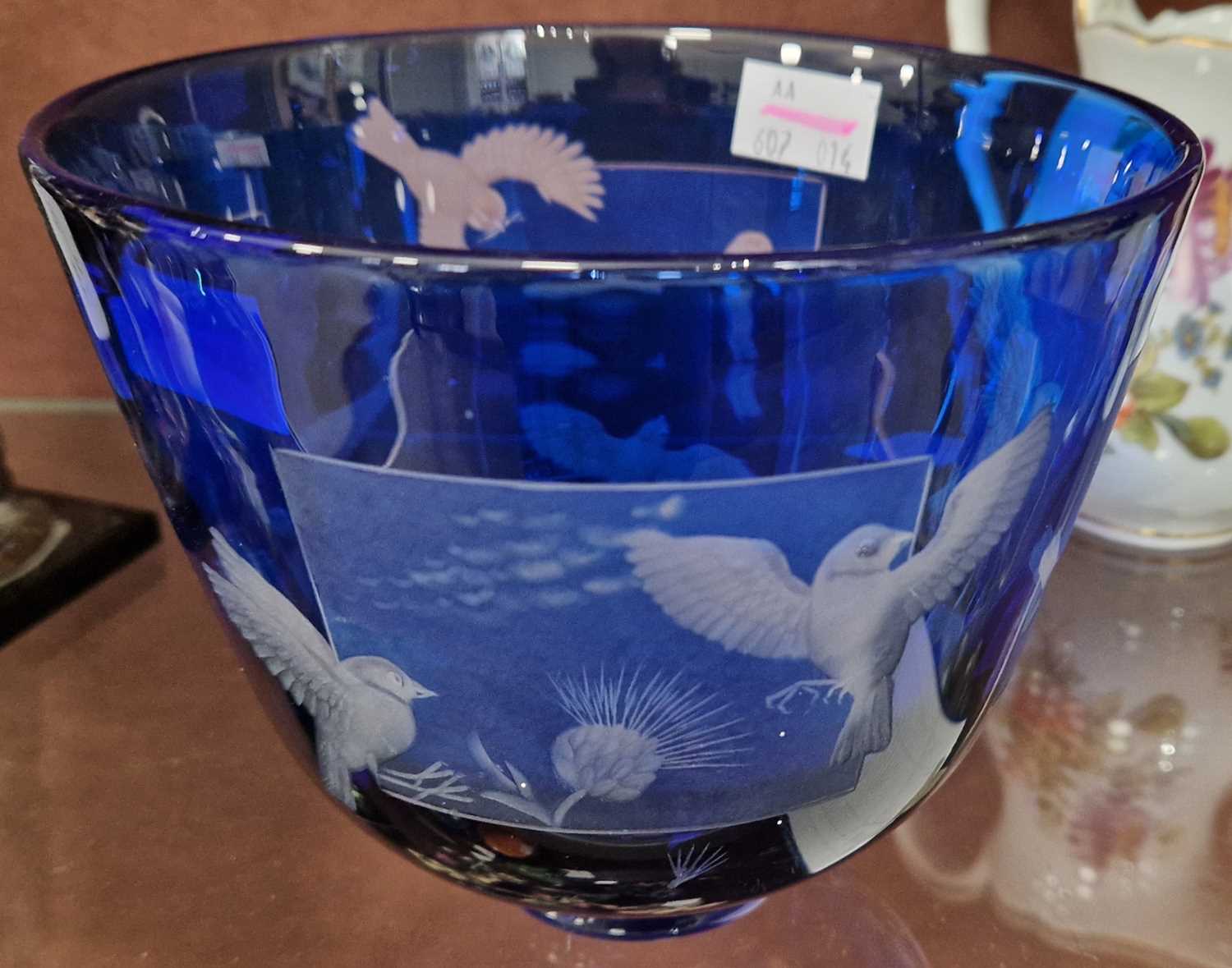 A 20th century Bristol blue glass overlaid bowl with wheel-cut decoration to reveal birds in flight,