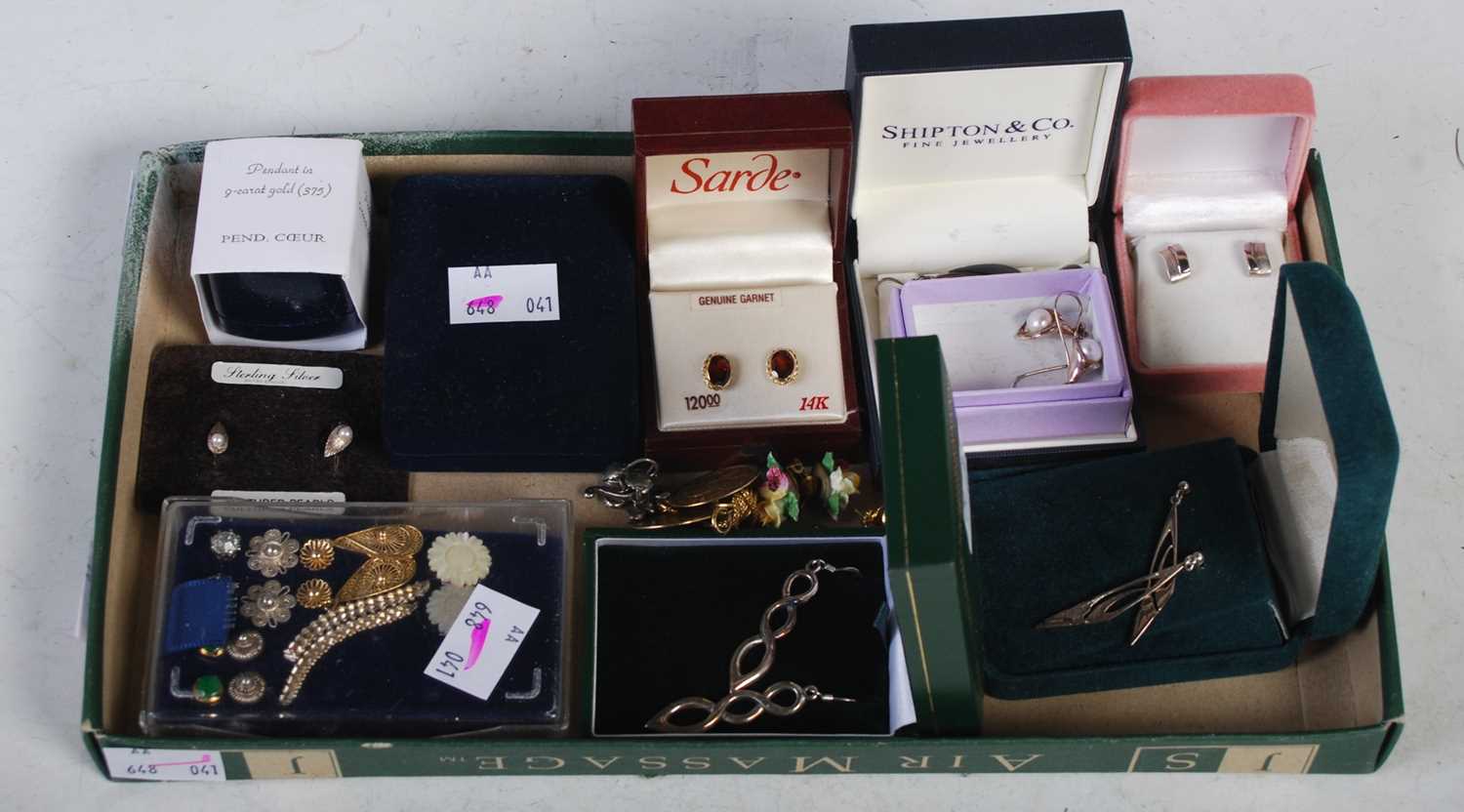 A box of assorted loose and boxed earrings.
