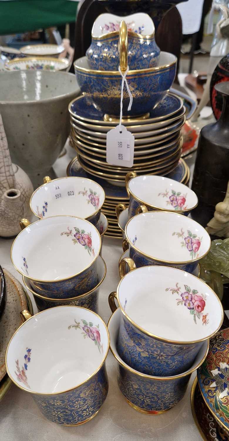 A Victorian part tea set, the exterior of blue ground with richly gilded floral details, the