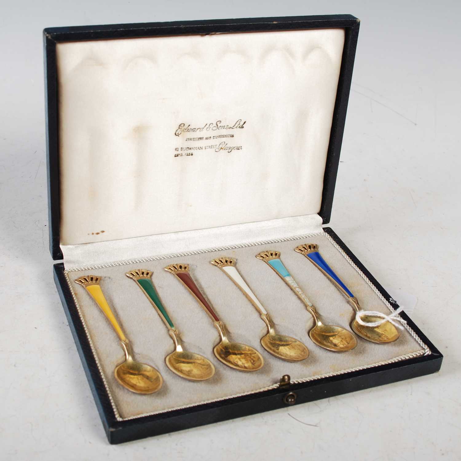 A cased set of six Danish sterling silver gilt and enamel coffee spoons.