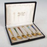 A cased set of six Danish sterling silver gilt and enamel coffee spoons.