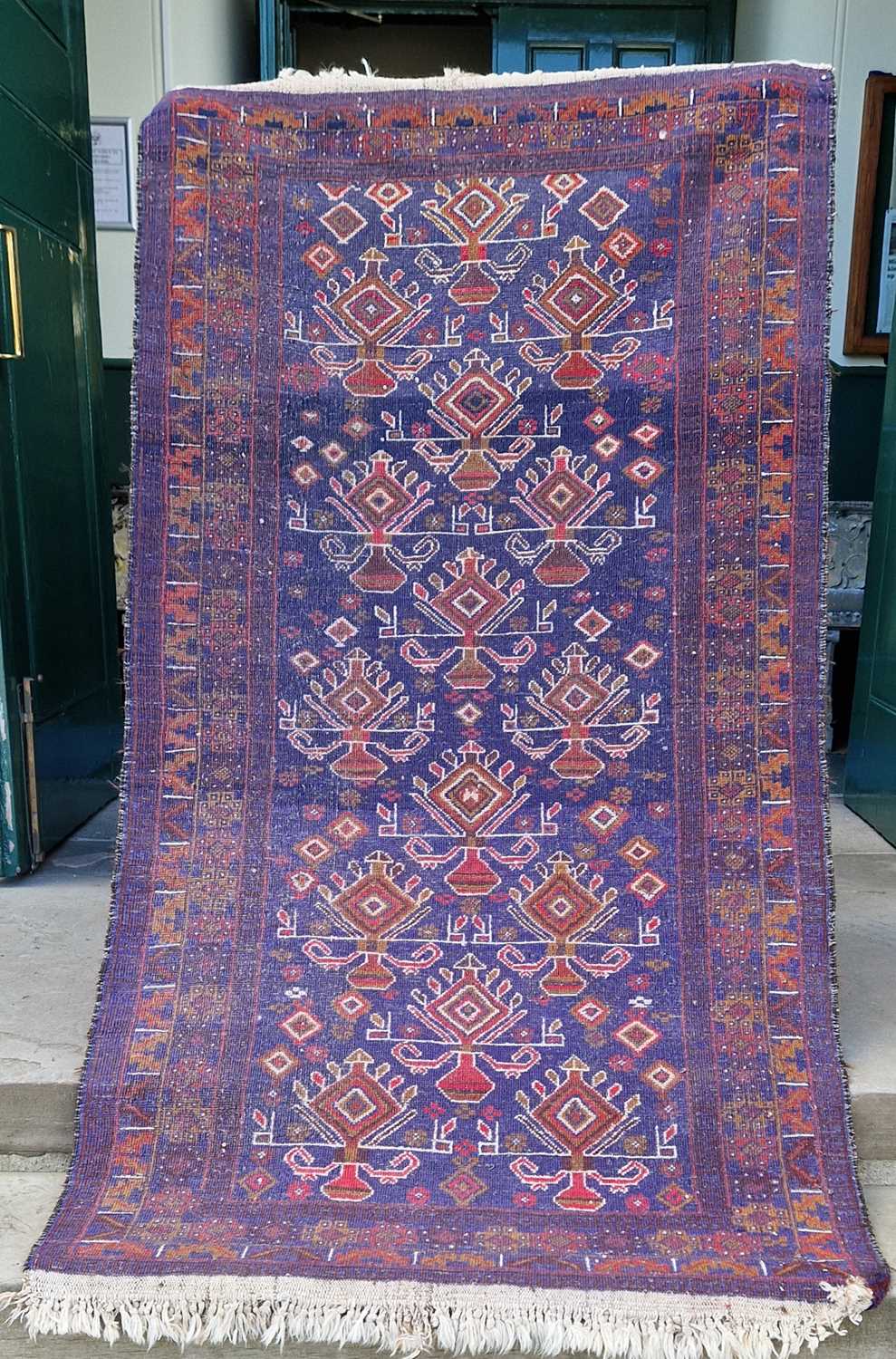 A Persian rug, 20th century, the blue ground decorated in white madder and ochre coloured threads - Image 2 of 4