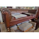 A Victorian oak club sofa with brown leather upholstered detail, raised on turned feet with later