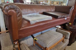 A Victorian oak club sofa with brown leather upholstered detail, raised on turned feet with later