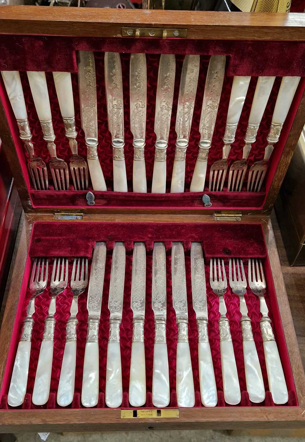 A late 19th/ early 20th century mahogany cased set of twelve EP and mother of pearl fish knifes