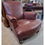 A Victorian oak brown leather upholstered club arm chair with studded detail.