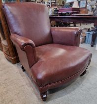 A Victorian oak brown leather upholstered club arm chair with studded detail.