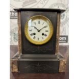 An antique slate and marble mantle clock with etched floral details, the white enamel dial with