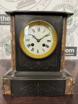An antique slate and marble mantle clock with etched floral details, the white enamel dial with