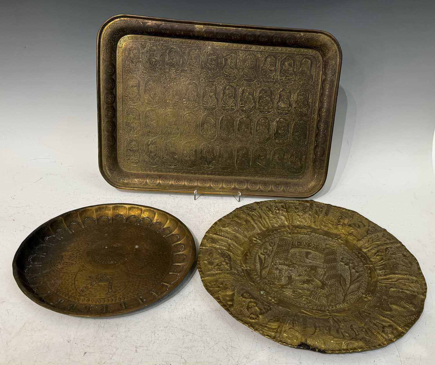 A collection of antique and later brass and copper wares to include a circular embossed wall