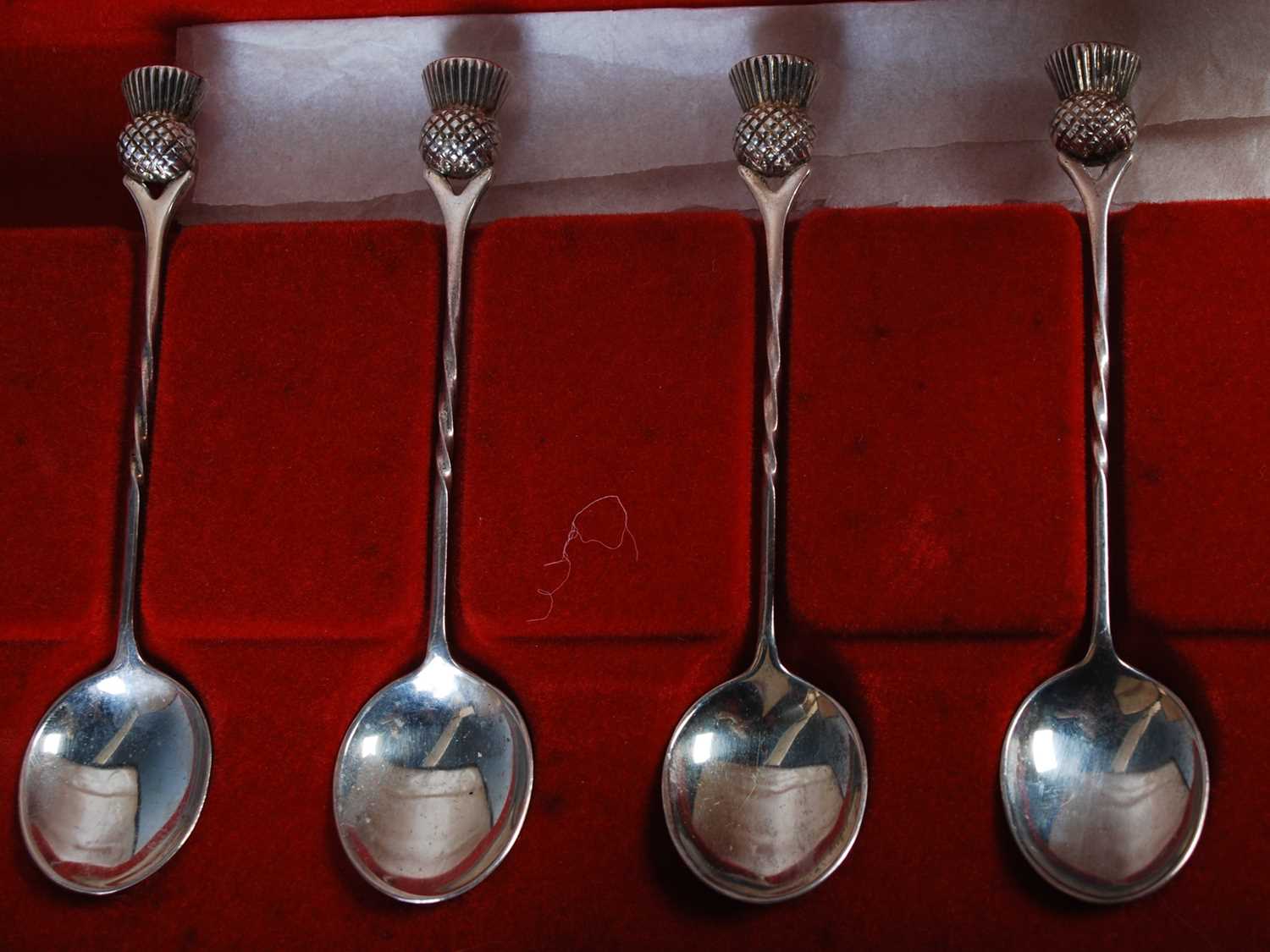 A cased set of six 20th century silver thistle topped teaspoons, Birmingham, 1975, together with a - Image 3 of 3