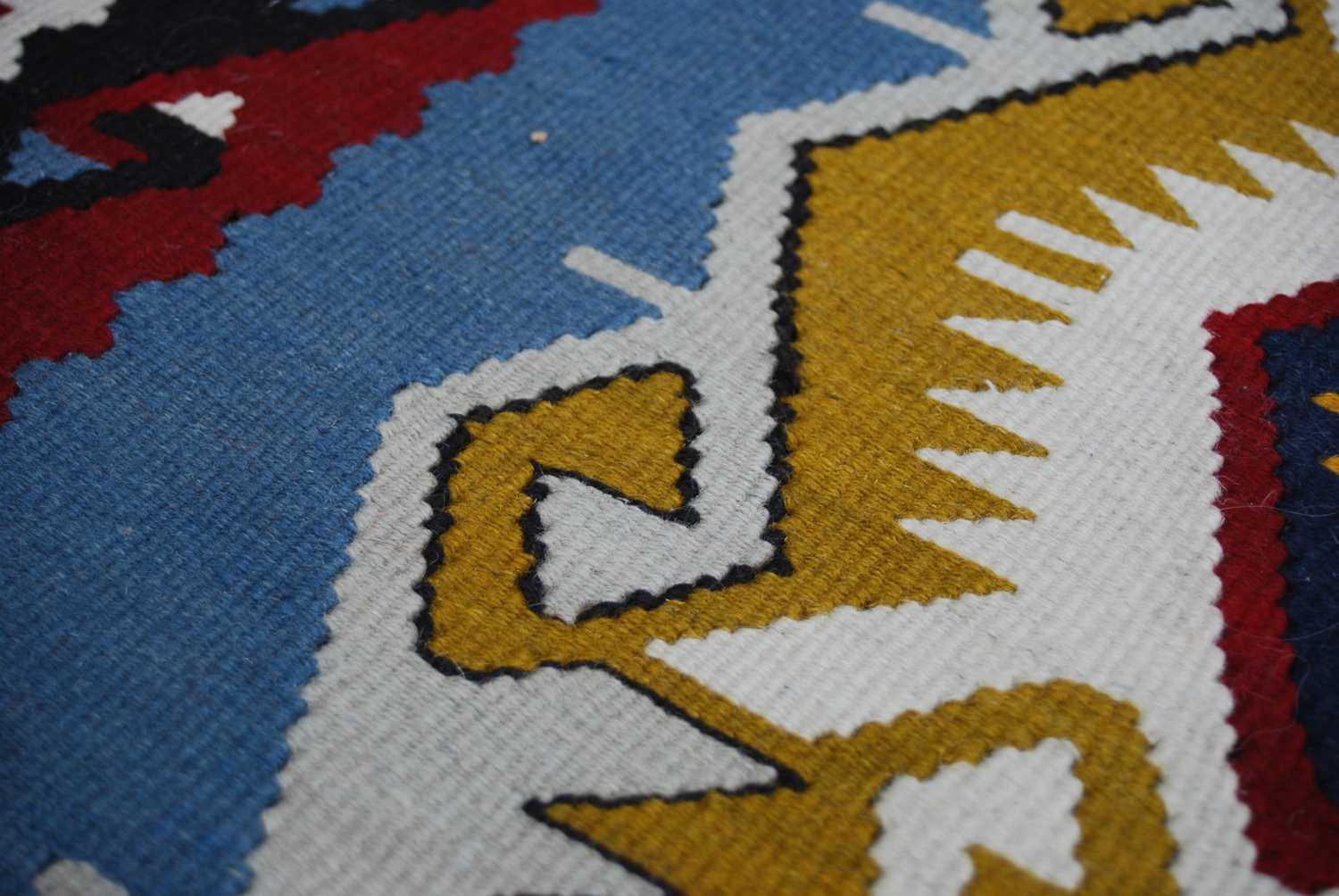 A Kelim rug, 20th century, the rectangular blue ground centred with a row of three lozenge shaped - Image 5 of 5