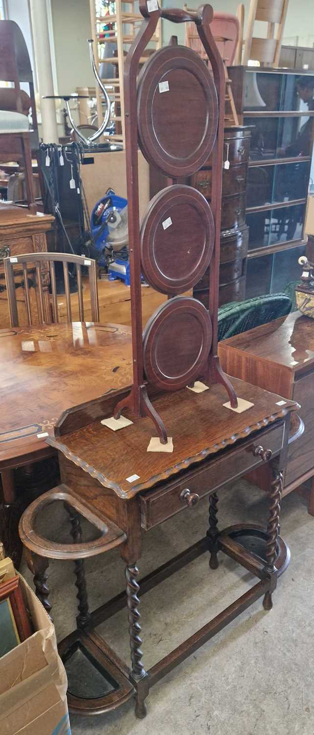 An early 20th century stained oak vestibule table with single drawer, spiral carved supports and two