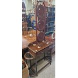 An early 20th century stained oak vestibule table with single drawer, spiral carved supports and two