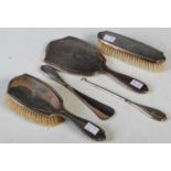 A Birmingham silver five piece dressing table set, comprising mirror, two brushes, shoehorn and boot