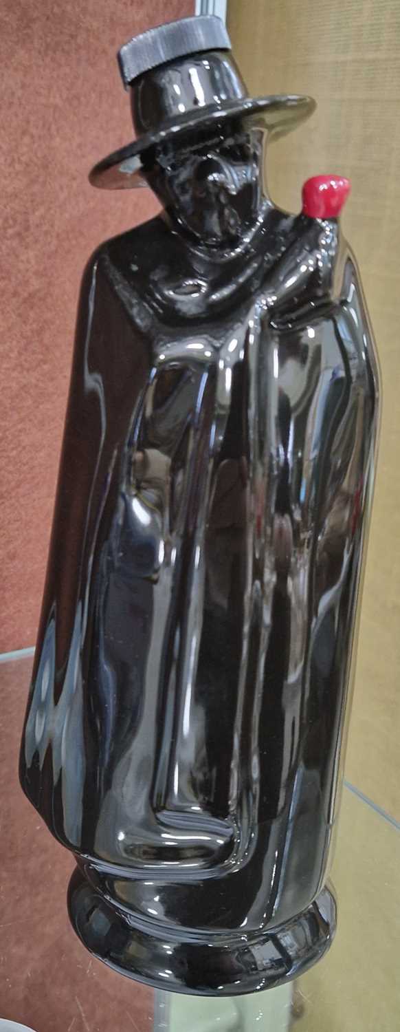 A Wade pottery decanter in the form of a black glazed figure wearing a cloak, printed marks, 21.