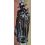 A Wade pottery decanter in the form of a black glazed figure wearing a cloak, printed marks, 21.