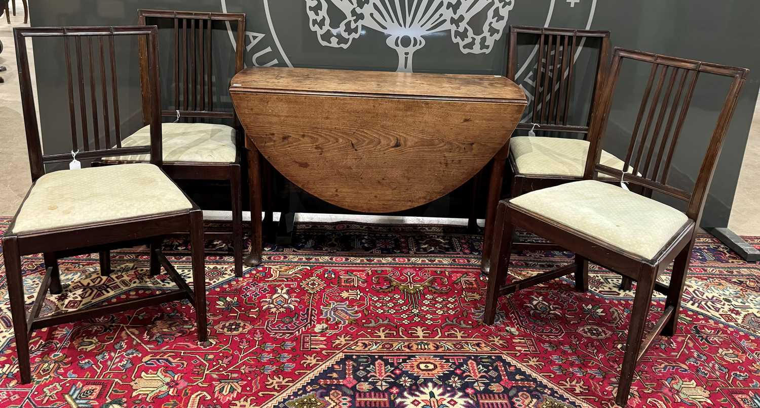 A George III mahogany drop leaf table, together with four 19th century mahogany dining chairs.